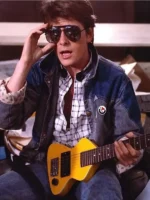 Marty McFly wearing denim jacket with sunglasses and guitar in Back to the Future movie still