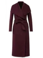 Burgundy long coat from The Recruit worn by Amelia Salazar, featuring a wrap front and modern trench design.