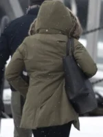 Meghan Markle in Harry & Meghan hooded parka, featuring a warm fur-lined hood and olive green color
