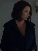 Tully Hart wearing a stylish black coat in Firefly Lane Season 2, giving a confident and elegant winter look