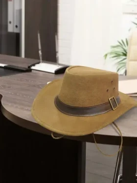 1923 Spencer Dutton brown suede safari fedora with leather buckle band resting on wooden desk lifestyle product shot