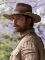 Brandon Sklenar as Spencer Dutton wearing dark brown wide-brimmed safari fedora side view in 1923 Paramount+ series
