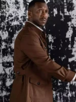 Mahershala Ali wearing a brown cotton utility jacket with four front flap pockets.