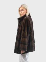 This trendy women's fur jacket is constructed from high-quality vegan material, providing a cruelty-free alternative for winter luxury. It features a prominent stand-up collar and a sleek button closure for a seamless look.