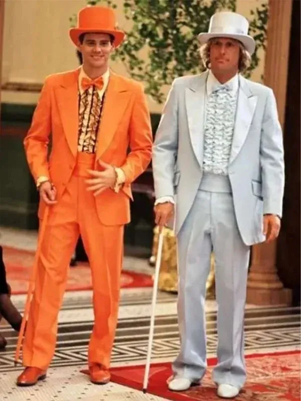 Jim Carrey as Lloyd Christmas in orange tuxedo and Jeff Daniels as Harry Dunne in grey suit from Dumb and Dumber 1994