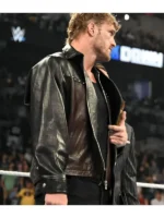 Dynamic shot of a personality gesturing while wearing a custom-recreated leather outerwear garment.