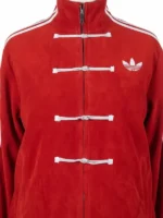 Men's red suede jacket with white stripes on the sleeves and traditional toggle buttons.