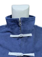 A close-up shot of the gold-tone zipper pull and the red-lined interior of a black Adidas Chinese New Year jacket.