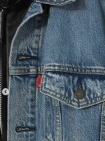 Close up of the functional chest pockets with button flaps on the Eddie Munson denim leather jacket