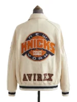 The back view of a collared jacket on a mannequin, dominated by a large circular basketball graphic in the center and block lettering across the lower hem.