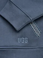 Close up of the small UGG logo patch on the blue pocket.