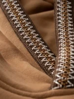 Detail shot of the colorful embroidery on the brown fleece.