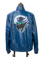 Full rear view of the blue Mortal Kombat II Johnny Cage leather jacket, highlighting the large multi-colored ninja art graphic centered across the back.
