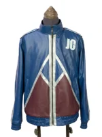 Straight-on front view of the blue Mortal Kombat II Johnny Cage jacket worn by Karl Urban, showcasing the white "JC" emblem and maroon triangular patterns across the waist.