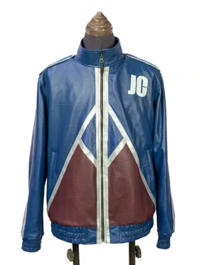 Straight-on front view of the blue Mortal Kombat II Johnny Cage jacket worn by Karl Urban, showcasing the white "JC" emblem and maroon triangular patterns across the waist.