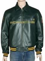 Front view of the premium dark forest green Aimé Leon Dore × Porsche 993 leather jacket displayed on a male mannequin. Features include an embroidered gold 'PORSCHE' spell-out across the chest, a shirt-style collar, full-front zipper closure, slip pockets, and a black knit hem and cuffs detailed with double gold stripes.
