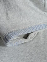 A grey pullover fleece hoodie with kangaroo pockets, advertised at a discounted price.