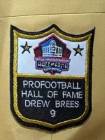 Premium gold suiting fabric jacket with commemorative patch.