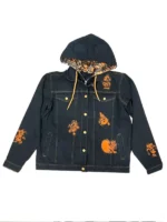 The sleeve of a black denim jacket featuring a screen-printed white-on-black skeleton design of Mickey Mouse running down the arm.