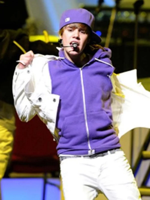Justin Bieber performing live in royal purple zip up hoodie and matching purple cap removing white jacket on stage during My World Tour