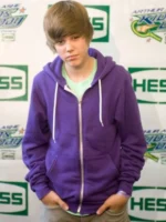 Justin Bieber wearing royal purple zip up hoodie with white drawstring at press event during My World era 2010