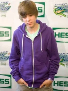 Justin Bieber wearing royal purple zip up hoodie with white drawstring at press event during My World era 2010
