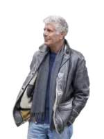 Anthony Bourdain wearing his iconic long grey Anthony Bourdain utility jacket with a knit scarf.