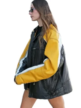 Hailey Bieber yellow leather jacket for women worn in a casual black outfit with sunglasses.