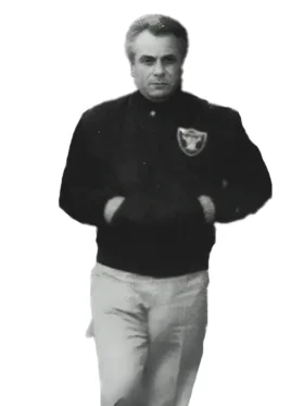 Black photo of John Gotti Raiders Jacket wearing an iconic black Oakland Raiders jacket. Dapper Don style.