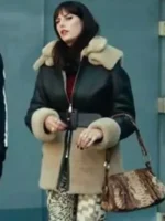 Kaya Scodelario in her statement brown Scodelario shearling leather coat from The Gentlemen, a luxurious shearling winter coat cinched with a black belt.