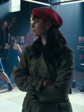 Kaya Scodelario wearing a fashionable checked long coat or wool plaid coat while observing a scene in a fighting gym.