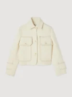 Susie Glass in her elegant White Wool Jacket from The Gentlemen 2024, as worn by Kaya Scodelario in a fierce, action-ready pose with a gun.