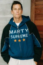 Full view of the iconic Marty Supreme jacket in navy blue and black with white text.