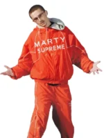 Styling view of the bright orange Marty Supreme jacket for a modern street look.