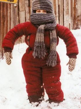 A Christmas Story snow suit costume featuring Randy wrapped in a restrictive red snowsuit and scarf.