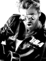 George Michael playing guitar in a Rockers Revenge studded leather jacket from the "Faith" music video.