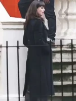 Full-length shot of Susie Glass in her sophisticated Netflix black coat, a key piece of her style in The Gentlemen series.