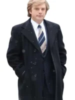 Sebastian Stan trench coat in a dark color with a wide collar, portraying Donald Trump in the film.