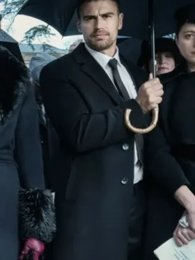 Theo James Eddie Horniman black coat from The Gentlemen 2024. This long, sophisticated wool coat is his signature trench style.