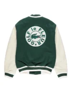 Tyler the Creator green varsity jacket and fur hat giving a speech on stage. Golf le Fleur style.