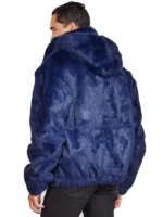 Man opening a navy blue faux fur jacket men to show the blue patterned lining. A fashionable mens navy hooded faux fur coat.