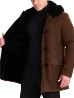 Long brown shearling sheepskin coat for men with black fleece lining and a classic toggle front.