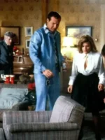 Randy Quaid as Cousin Eddie wearing full powder blue leisure suit standing in Griswold living room with Christmas decorations in National Lampoon Christmas Vacation
