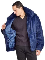 Full-length shot of a man wearing a mens navy blue faux fur bomber jacket over black pants and dress shoes.