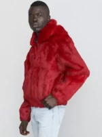 Striking red fox fur jacket mens with a large collar, worn over light-wash jeans. A stylish fur jacket men.