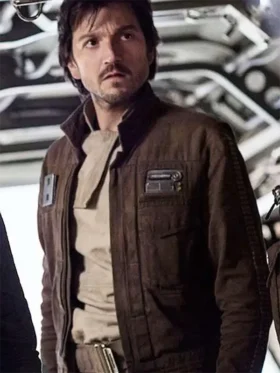 A man wearing a dark brown rebel-style jacket with a yellow badge, inspired by Cassian Andor.
