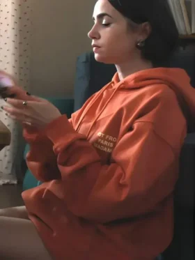A trendy Orange Slogan Hoodie as seen on Lily Collins in the hit series.