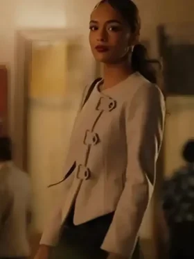 Thalia Besson as Geneviève in Emily in Paris S05 wearing a modern black asymmetric tailored jacket.