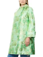 Lily Collins wearing a Floral Jacquard Coat with a vibrant green base and ornate botanical patterns.