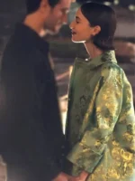 Lily Collins wearing a Green Floral Jacquard Coat with an intricate leaf pattern and structured fit.